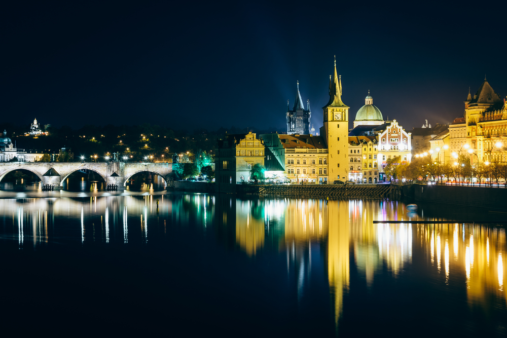 Charles Bridge and buildings along the Vltava at night, in Prague, Czech Republic.